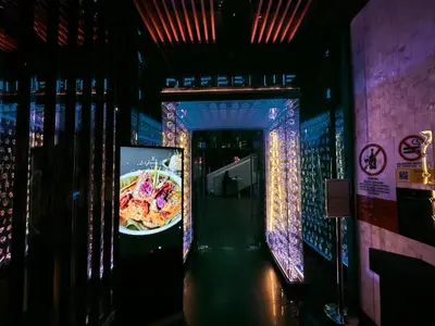 a hallway of a restaurant with a plate of food at Platinum Klcc by StayAura in Kuala Lumpur