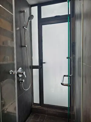 a shower with a glass door in a bathroom at Arte Mont Kiara by whitedoorz Apartment in Kuala Lumpur