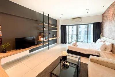 a living room with a bed and a couch at Summer Suites KLCC Vibes in Kuala Lumpur