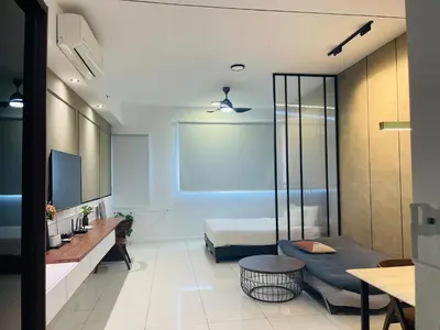 a room with a bed and a couch and a table at Chambers residence klcc by Gajilion in Kuala Lumpur