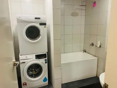 a bathroom with a washing machine and a tub at Chambers residence klcc by Gajilion in Kuala Lumpur