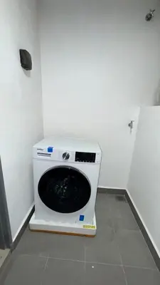 a washing machine sitting in a corner of a room at M Arisa Sentul KL City view in Kuala Lumpur