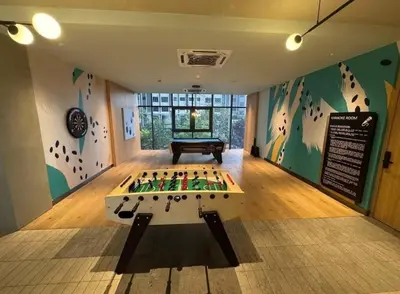 a room with a foosball table in the middle of a room at M Arisa Sentul KL City view in Kuala Lumpur