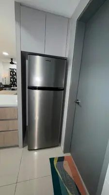 a kitchen with a stainless steel refrigerator in a room at M Arisa Sentul KL City view in Kuala Lumpur