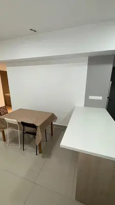 a room with a table and a table and chairs at M Arisa Sentul KL City view in Kuala Lumpur
