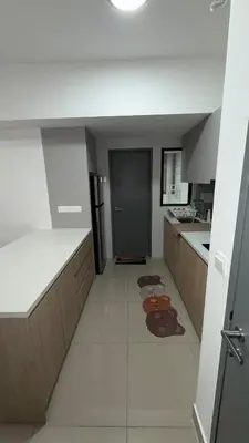 a large kitchen with white counters and a counter top at M Arisa Sentul KL City view in Kuala Lumpur