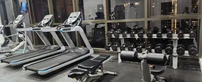 a gym with rows of treadmills and machines at Homestay at Wyndham Suites KLcc in Kuala Lumpur