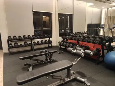 a gym with several rows of dumbbells on display at Homestay at Wyndham Suites KLcc in Kuala Lumpur