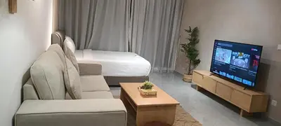 a living room with a couch and a tv at Homestay at Wyndham Suites KLcc in Kuala Lumpur