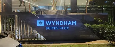 a sign for the wmutian surfaces kcc in front of a building at Homestay at Wyndham Suites KLcc in Kuala Lumpur
