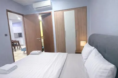 a bedroom with a white bed and a mirror at Sky Suites KLCC By Sky Management in Kuala Lumpur