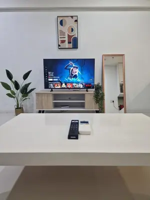 a living room with a white table and a tv at Summer suites klcc 5 min walk by AA Global in Kuala Lumpur