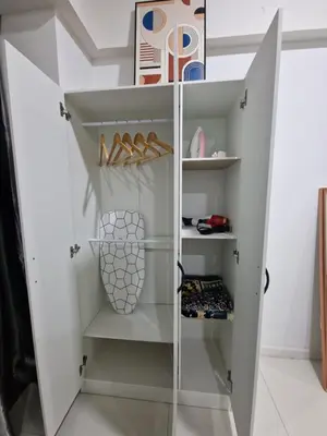 a white closet with shoes on shelves at Summer suites klcc 5 min walk by AA Global in Kuala Lumpur