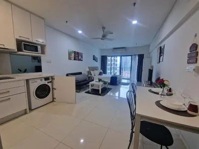 a kitchen and living room with a table and a living room at Summer suites klcc 5 min walk by AA Global in Kuala Lumpur