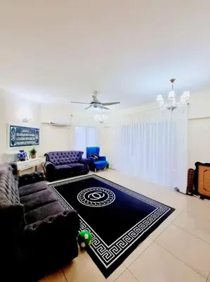 a living room with a couch and a rug at Shahana Homestay KL for musleem in Kuala Lumpur