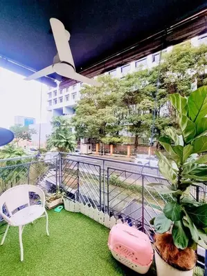a balcony with a white chair and a plant at Shahana Homestay KL for musleem in Kuala Lumpur