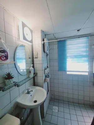 a white bathroom with a sink and a mirror at Shahana Homestay KL for musleem in Kuala Lumpur
