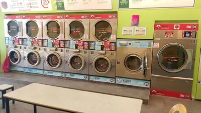 a row of washers and dryers in a store at The Colony Infinitum KLCC Suits By Sabu in Kuala Lumpur