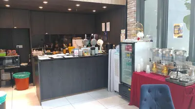 a kitchen with a counter and a refrigerator at The Colony Infinitum KLCC Suits By Sabu in Kuala Lumpur