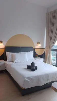 a bedroom with a large bed with a hat on it at The Colony Infinitum KLCC Suits By Sabu in Kuala Lumpur