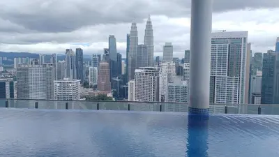 a view of a city skyline from a swimming pool at The Colony Infinitum KLCC Suits By Sabu in Kuala Lumpur