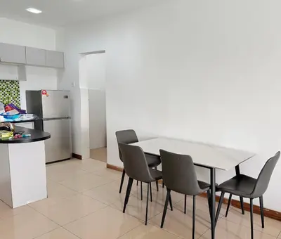 a kitchen with a table and chairs and a refrigerator at Happy Homes Kuala Lumpur Rooms in Kuala Lumpur