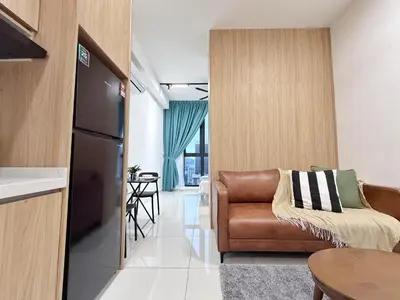 a living room with a couch and a kitchen at Majestic Unique Studio Suite with Infinity Pool in Kuala Lumpur