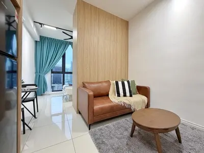 a living room with a brown leather chair and a table at Majestic Unique Studio Suite with Infinity Pool in Kuala Lumpur