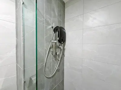 a shower in a bathroom with a phone on the wall at Majestic Unique Studio Suite with Infinity Pool in Kuala Lumpur