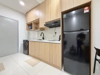 a kitchen with a sink and a refrigerator at Majestic Unique Studio Suite with Infinity Pool in Kuala Lumpur