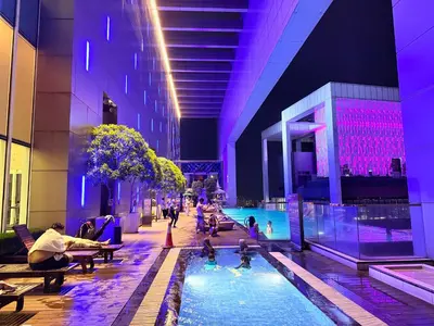 a pool in a building with people sitting in the water at White stone suites in Kuala Lumpur