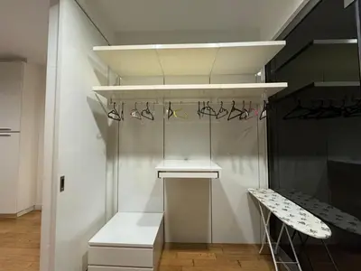a walk in closet with a shelf and shoes at White stone suites in Kuala Lumpur