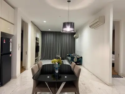 a dining room with a black table and chairs at White stone suites in Kuala Lumpur