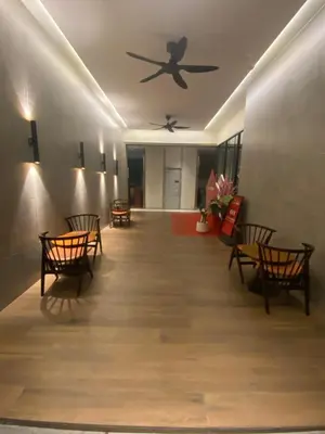 a hallway with chairs and a ceiling fan at Agile Bukit Bintang Save Home in Kuala Lumpur