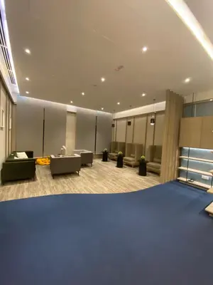 a large room with a lobby with couches and desks at Agile Bukit Bintang Save Home in Kuala Lumpur