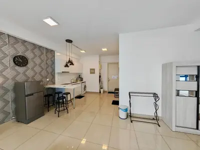 a large white kitchen with a counter and a table at Arte Plus by Jerry in Kuala Lumpur