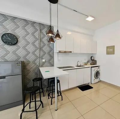 a kitchen with a table and some chairs in it at Arte Plus by Jerry in Kuala Lumpur