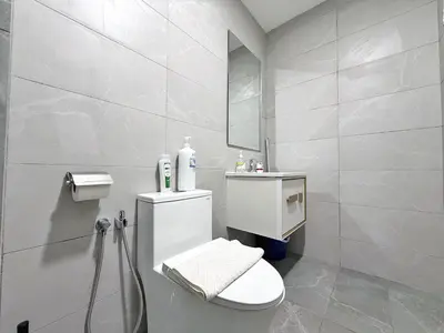 a white bathroom with a toilet and a sink at Majestic Wonder Studio Suite with Infinity Pool in Kuala Lumpur