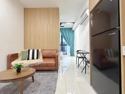 a living room with a couch and a table at Majestic Wonder Studio Suite with Infinity Pool in Kuala Lumpur