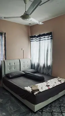 a large bed in a room with a ceiling at Homestay in Kuala Lumpur