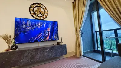 a living room with a large flat screen tv on a wall at Jalan Ampang KLCC Embassy Area Homestay in Kuala Lumpur
