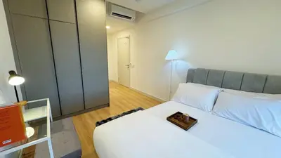 a bedroom with a white bed with a plate on it at Jalan Ampang KLCC Embassy Area Homestay in Kuala Lumpur