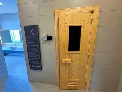 a wooden door in a wall with a sign at Jalan Ampang KLCC Embassy Area Homestay in Kuala Lumpur