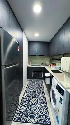a kitchen with a refrigerator and a washer and dryer at Jalan Ampang KLCC Embassy Area Homestay in Kuala Lumpur