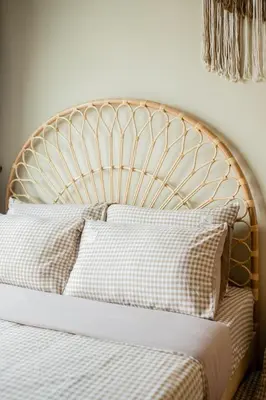 a bed with a gold headboard and pillows on it at Legasi Residence By Feel Home in Kuala Lumpur