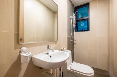 a bathroom with a sink and a toilet and a mirror at Legasi Residence By Feel Home in Kuala Lumpur
