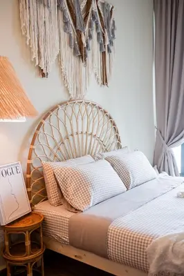 a bed with a wooden headboard in a bedroom at Legasi Residence By Feel Home in Kuala Lumpur