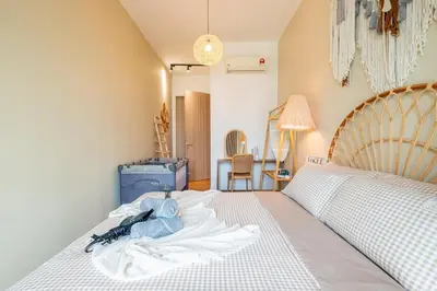 a bedroom with a large bed with white sheets and a bed sqor at Legasi Residence By Feel Home in Kuala Lumpur