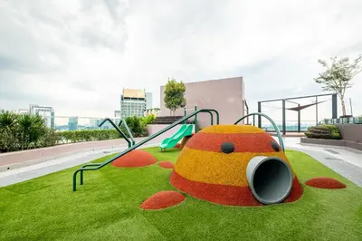a playground with a toy on the grass at 38 Bangsar by Feel Home in Kuala Lumpur