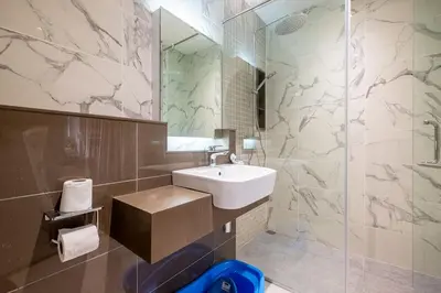 a bathroom with a sink and a mirror at 38 Bangsar by Feel Home in Kuala Lumpur